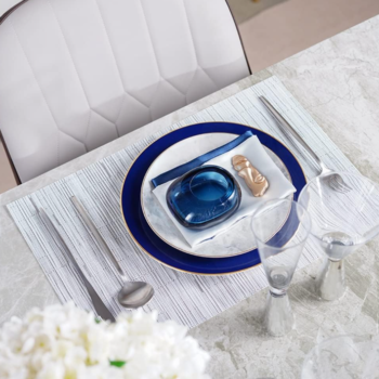 Blue ceramic dinnerware set with Western-style plates, placemats, and napkin rings
